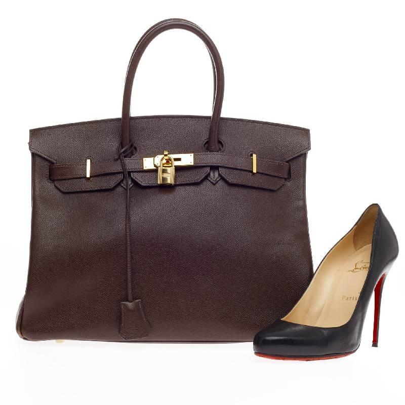 This authentic Hermes Birkin Brown Epsom with Gold Hardware 35 stands as one of the most-coveted bags. Constructed in structured, scratch-resistant chocolate brown epsom leather, this stand-out tote features dual-rolled top handles, frontal flap,