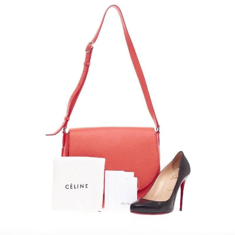 This authentic Celine Trotteur Crossbody Grainy Leather in minimalist yet elegant design is perfect for on-the-go fashionistas. Crafted in beautiful coral grainy leather, this saddle-inspired crossbody features a frontal flap, exterior back pocket,