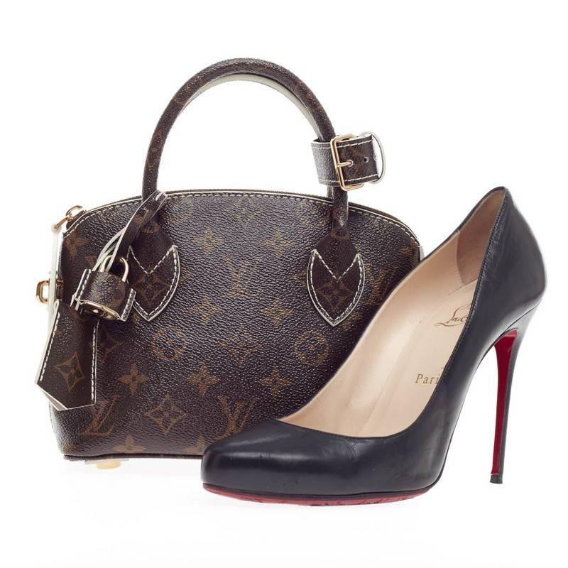This authentic Louis Vuitton Lockit BB Monogram Fetish Canvas released during Fall/Winter 2011/2012 plays on structured design with a modern flair showcasing its iconic Lockit model. Crafted in Louis Vuitton's updated brown monogram canvas with