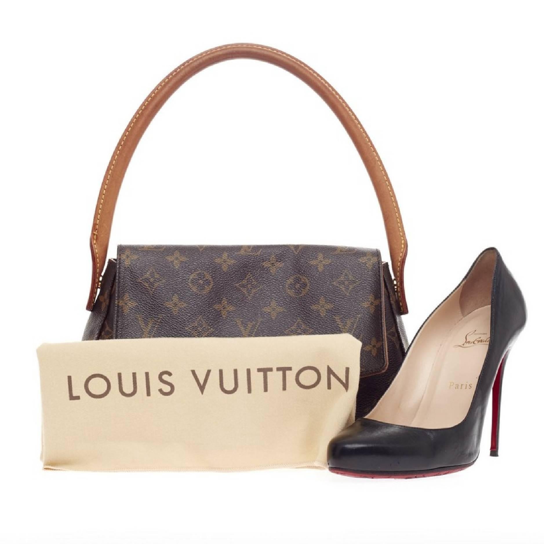 This authentic Louis Vuitton Looping Monogram Canvas Mini is sturdy in its size and showcases the brand's monogram canvas print. The smallest of the Looping collection, this bag features an arched vachetta leather handle giving the bag structure and