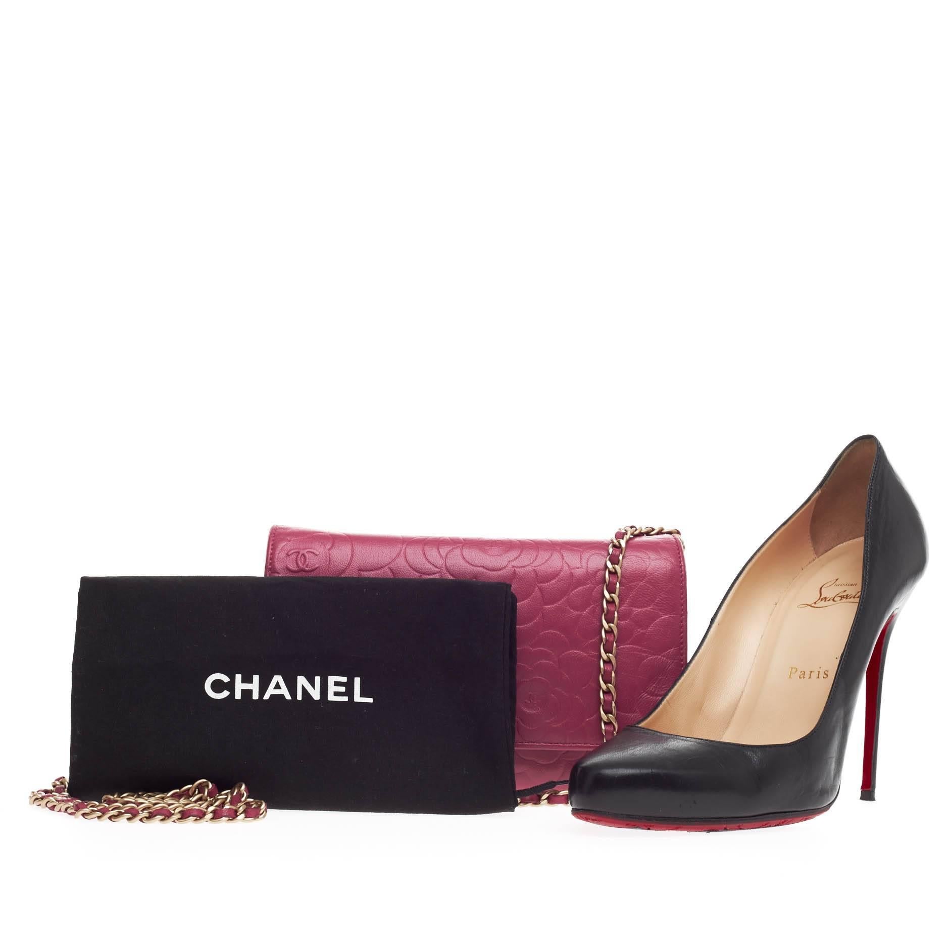 This authentic Chanel Wallet on Chain Camellia Lambskin showcases an effortlessly classic and feminine style perfect for on-the-go moments. Crafted in beautiful fuchsia lambskin leather with an abstract embossed camellia pattern, this petite chain