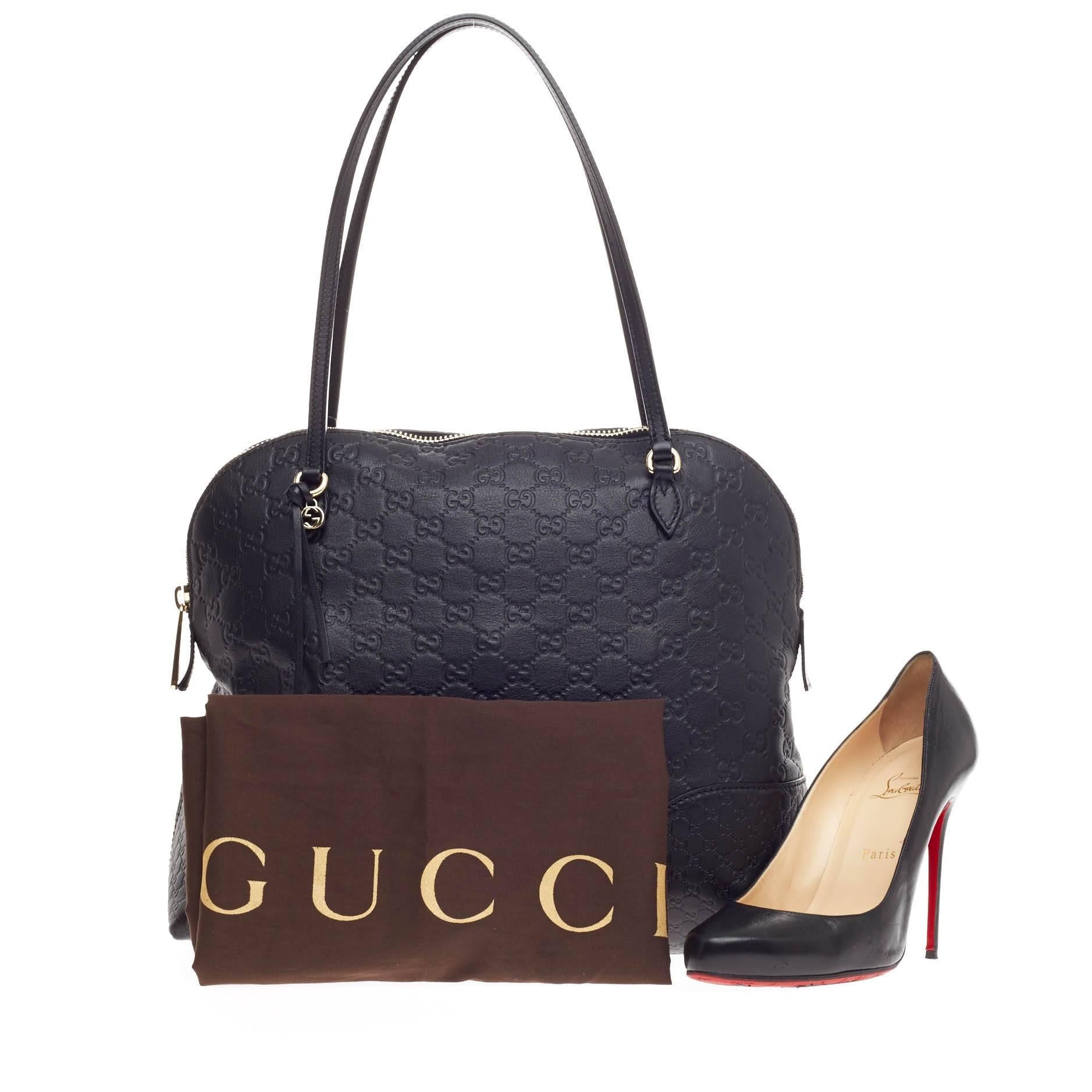 This authentic Gucci Bree Dome Tote Guccissima Leather Medium is perfect for everyday casual look. Crafted in black guccissima leather, this dome-style tote features tall slim handles, small Gucci charm and gold-tone hardware accents. Its top zip