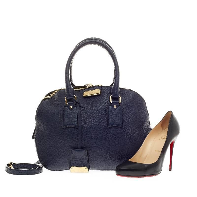 This authentic Burberry Orchard Bag Grained Leather Small has an elegant and simplistic design with a compact silhouette that is ideal for everyday use. Crafted from navy blue pebbled leather, this vintage-inspired bag features gold-tone hardware,