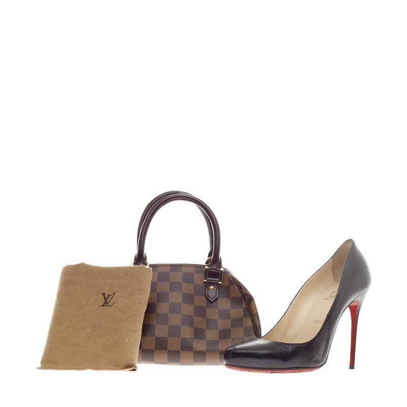 This authentic Louis Vuitton Ribera Damier Mini is an easy-to-carry, chic handle bag for the care-free woman. Crafted from Louis Vuitton's signature damier ebene canvas, this structured petite dome bag features dual-rolled leather handles, leather