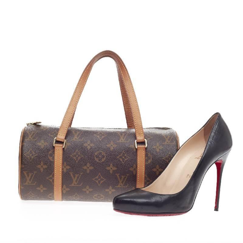 This authentic Louis Vuitton Papillon Monogram Canvas 26 is one of Louis Vuitton's iconic bags with its unique round shape that complements both dressy and casual looks. Crafted with brown monogram canvas print, this practical handle bag features
