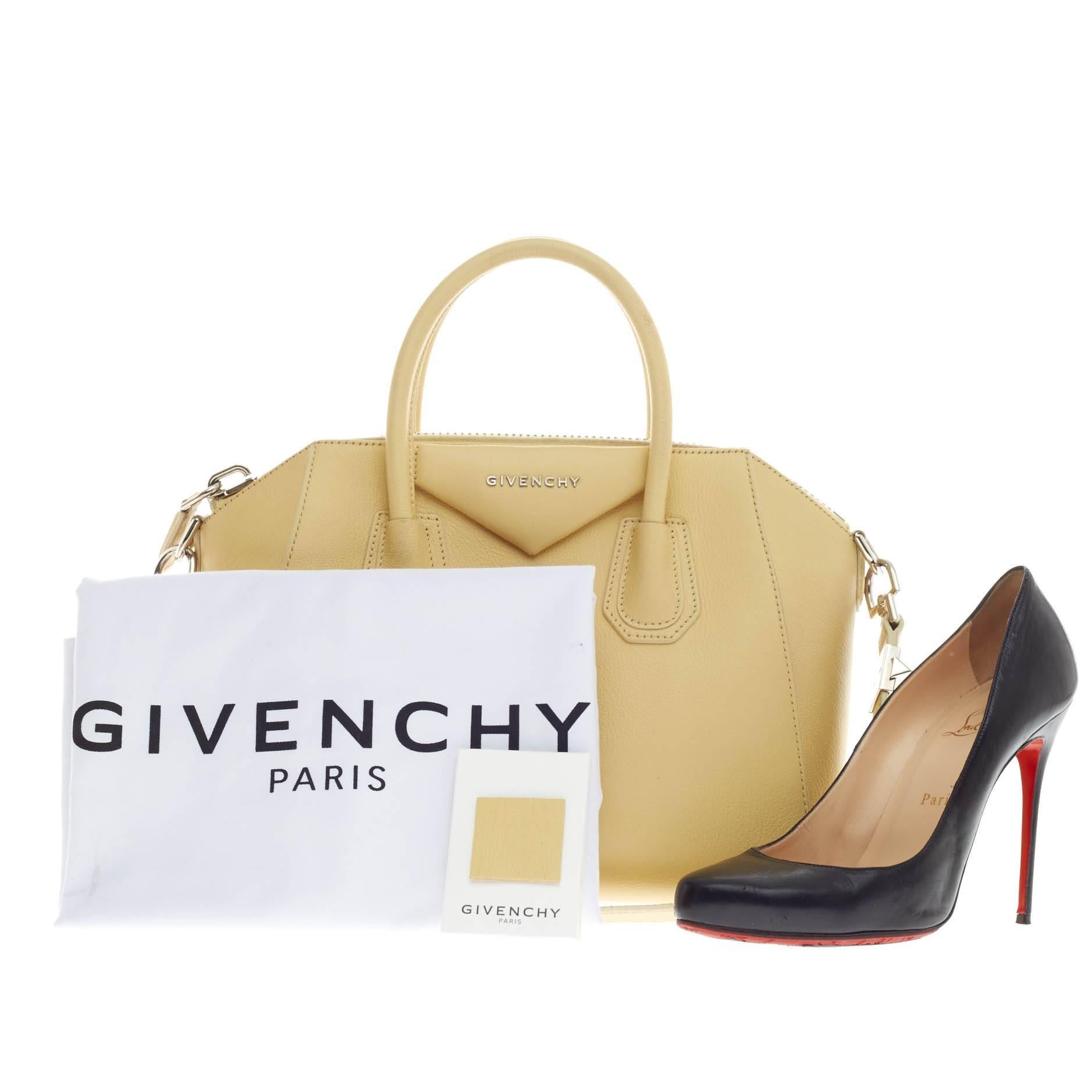 This authentic Givenchy Antigona Bag Leather Small is a go-to fashionista favorite. Constructed in beautiful pale yellow leather, this structured yet stylish tote features Givenchy's signature envelope fold logo in front, dual top handles,