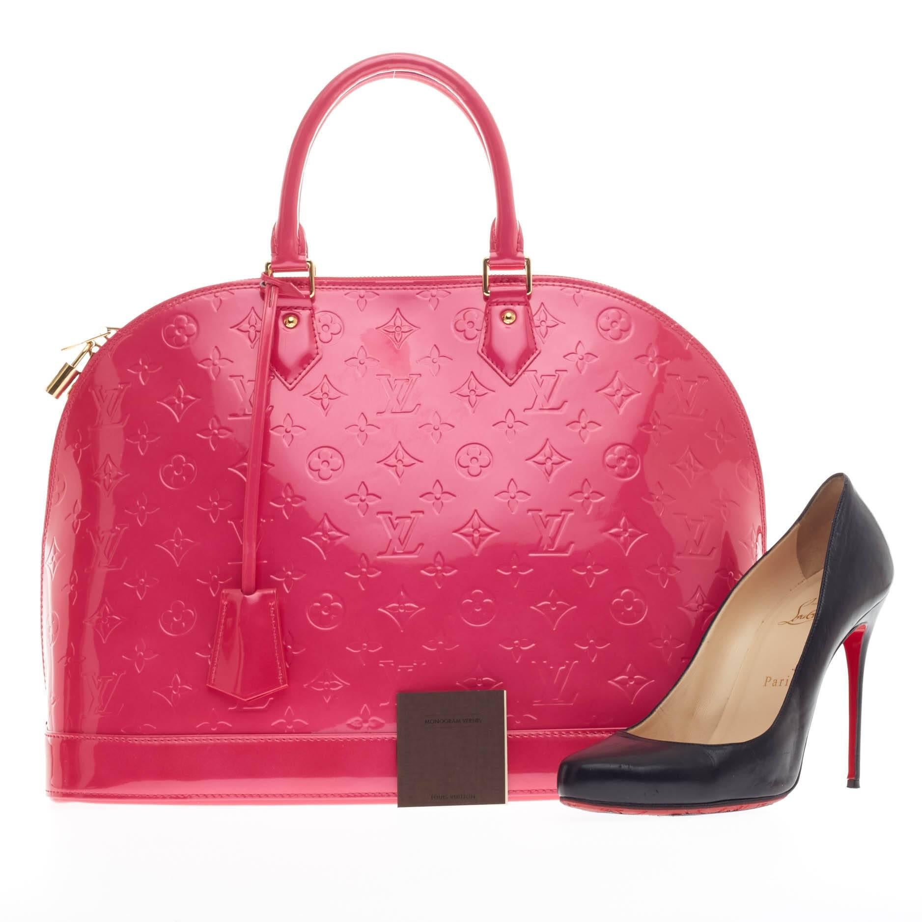 This authentic Louis Vuitton Alma Monogram Vernis GM is a fresh and elegant spin on a classic style that is perfect for all seasons. Crafted from Louis Vuitton's glossy vernis patent leather in beautiful rose pop pink, this dome-shaped satchel
