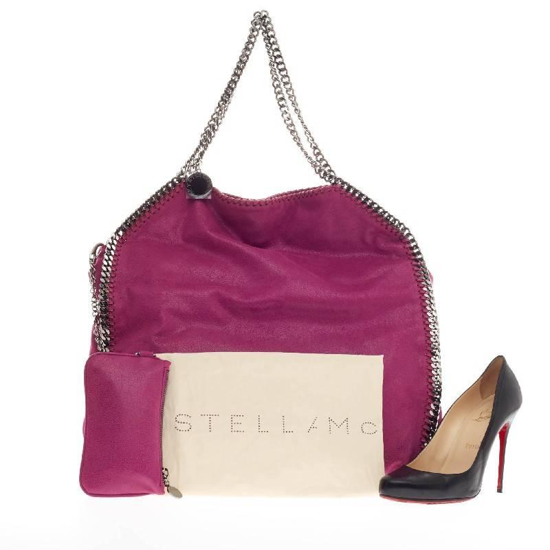 This authentic Stella McCartney Falabella Tote Shaggy Deer Large is perfectly textured with vivid fuschia pink shaggy deer polyester. This no-fuss, easy tote features gunmetal chain link handles and trim, whipstitched edges, and a hanging logo disc.