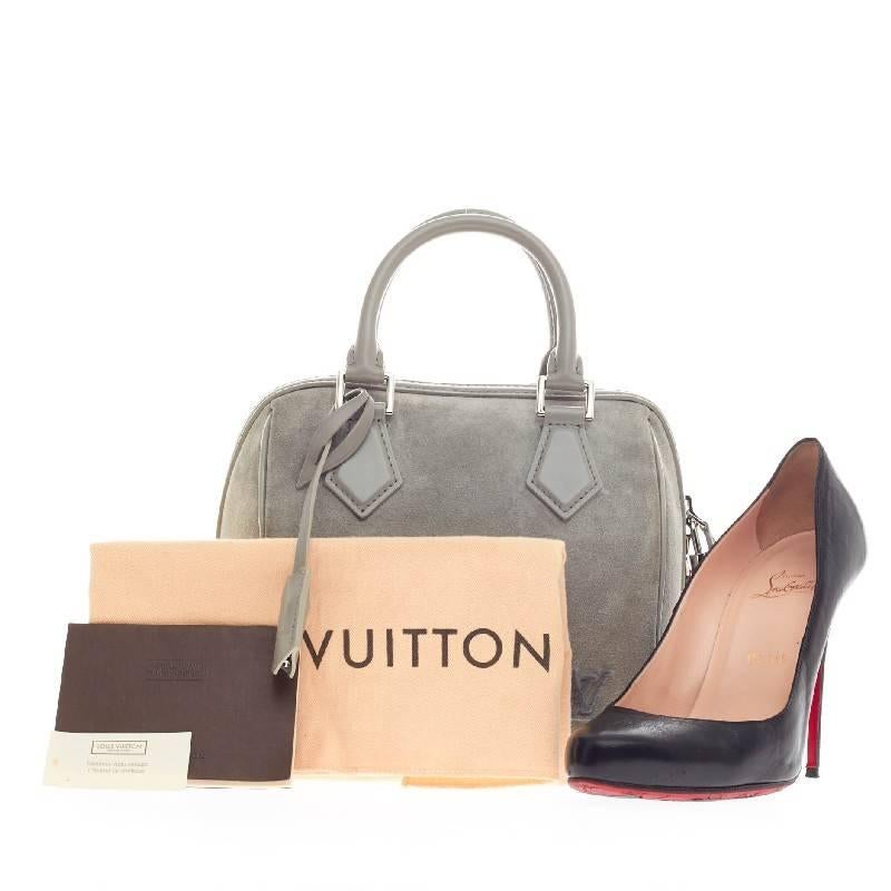 This authentic Louis Vuitton Speedy Cube Illusion PM released during Spring 2013 collection showcases the brand's classic speedy cube design. Crafted in blue gray soft suede and smooth calf leather with a tuffetage technique, this taller and slimmer