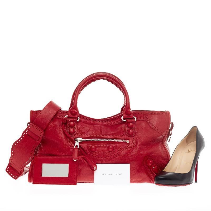 This authentic Balenciaga Part Time Giant Brogues Leather is a stylish tote perfect for everyday use. Crafted in vivid distressed red leather, this tote features signature braided top handles with perforated trim details, buckles accents and large