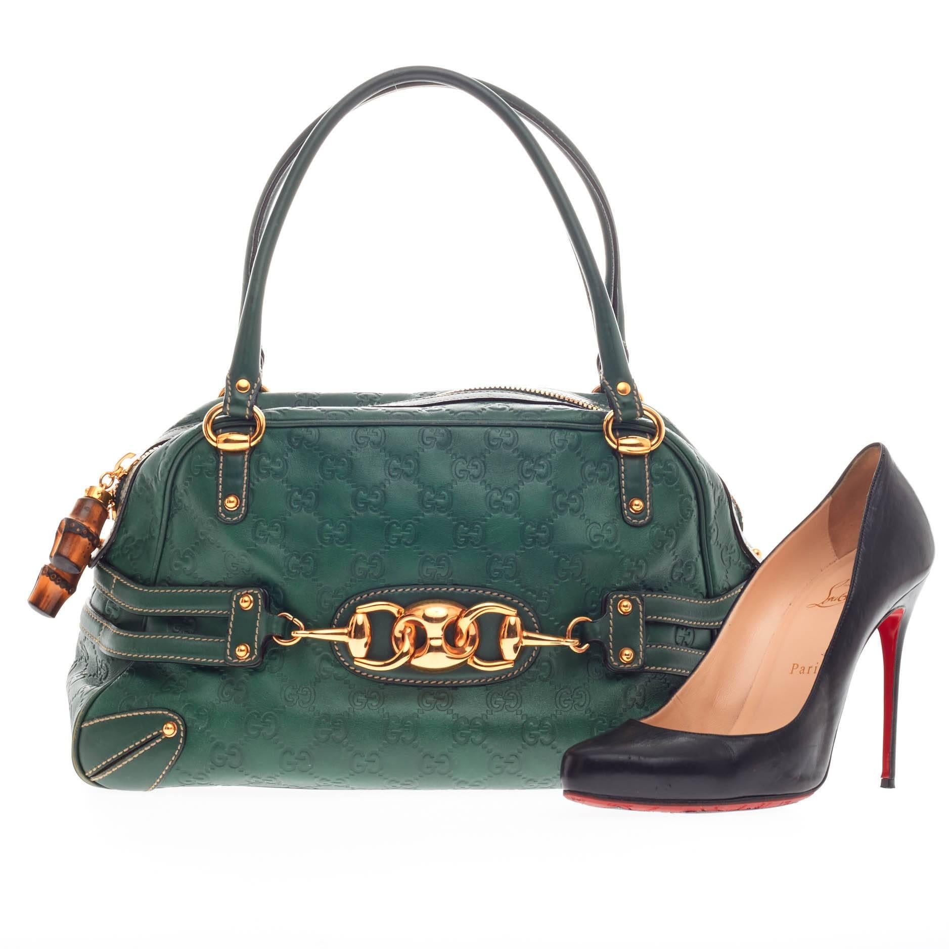 This authentic Gucci Wave Boston Bag Guccissima Leather Medium is perfect for all seasons. Crafted in green guccissima leather, this classic-style boston bag features dual-rolled handles, protective feet, bamboo pull zip charms, signature horsebit