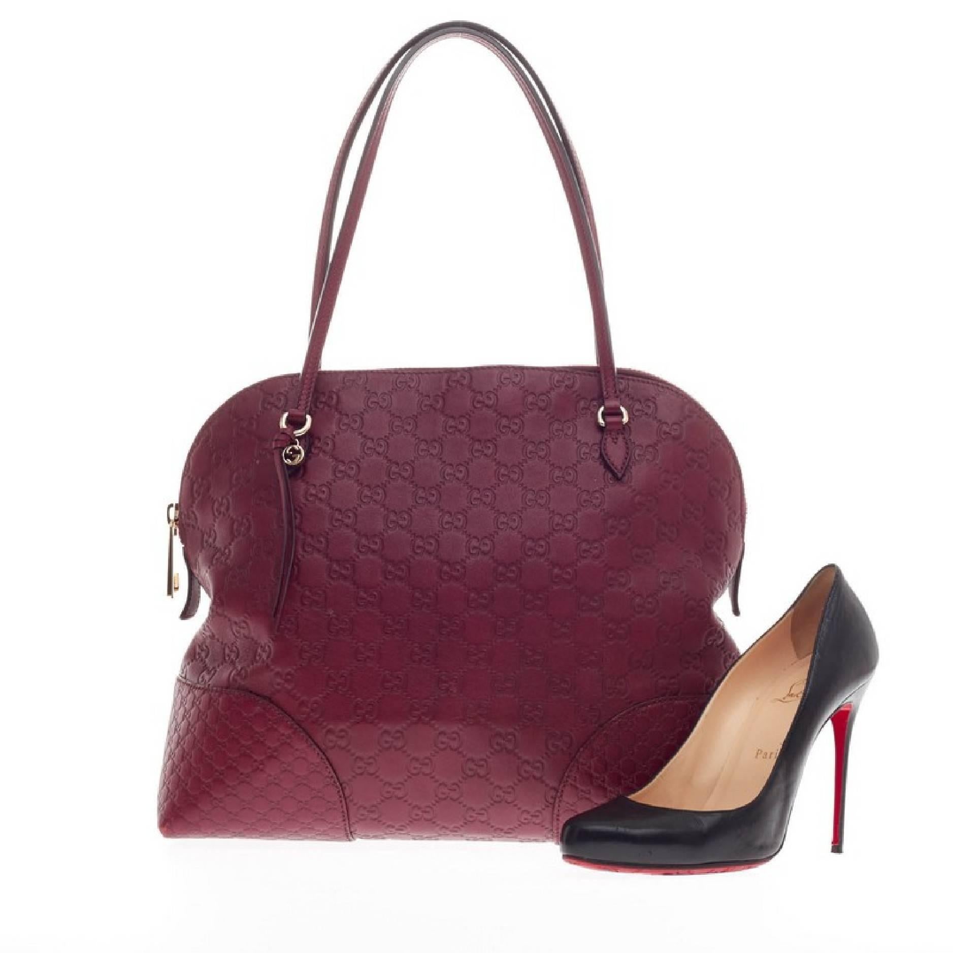 This authentic Gucci Bree Dome Tote Guccissima Leather Medium is perfect for everyday casual look. Crafted in ruby red guccissima leather with microguccissima leather detailing, this dome-style tote features tall slim handles, small Gucci GG charm