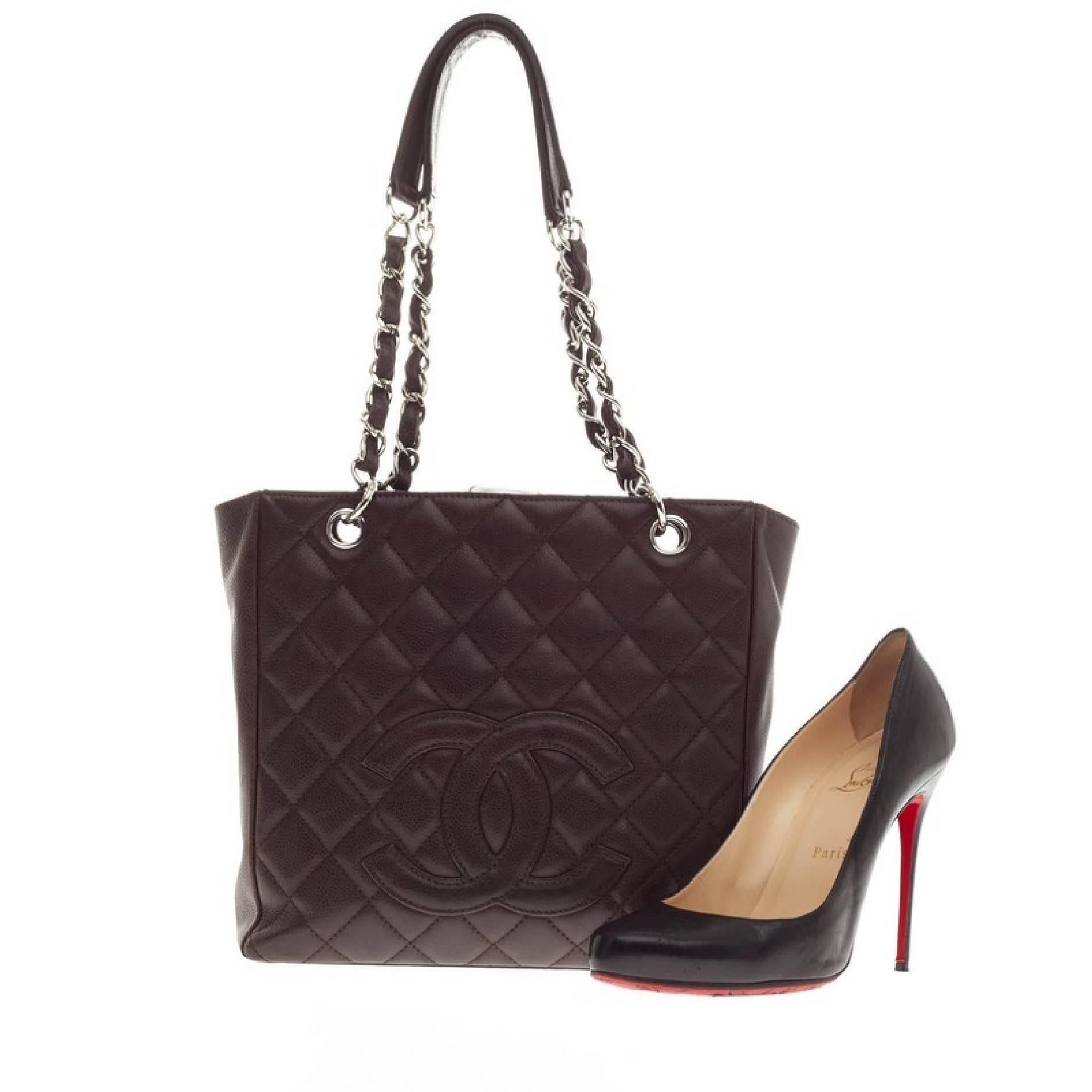 This authentic Chanel Petite Shopping Tote Caviar is made for everyday use. The interlaced double silver chain shoulder straps feature leather padding at the top for comfort and circular silver links. The bag features Chanel's rich dark brown