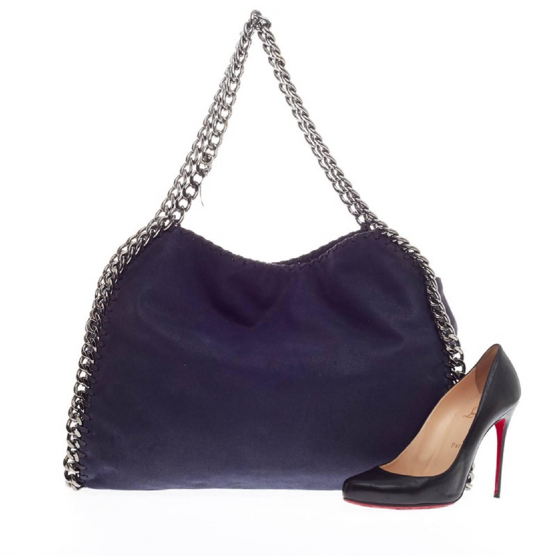 This authentic Stella McCartney Falabella Tote Shaggy Deer Small is perfectly textured in navy blue shaggy deer polyester. This no-fuss, easy tote features gunmetal chain link handles and trim, whipstitched edges, and a hanging logo disc. Its
