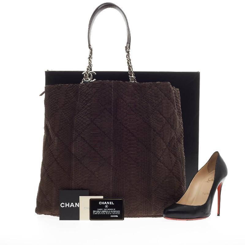 This authentic Chanel CC Charm Tote Quilted Matte Python Large showcases an elegant and luxurious design made for Chanel lovers. Crafted in rich brown genuine matte python skin, this chic, oversized tote features Chanel's signature diamond stitched