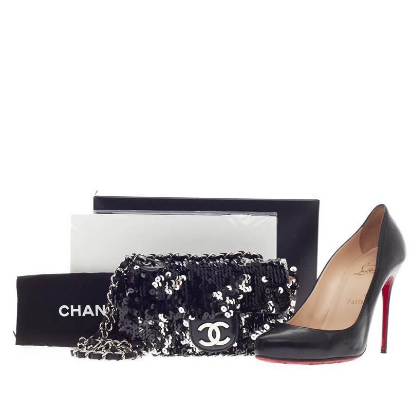 This authentic Chanel Flap Bag Sequin Mini is a playful and fun accessory perfect for special occasions and night outs. Embellished with shimmering black and silver sequins, this miniature bag features a frontal flap with CC logo, long woven-in