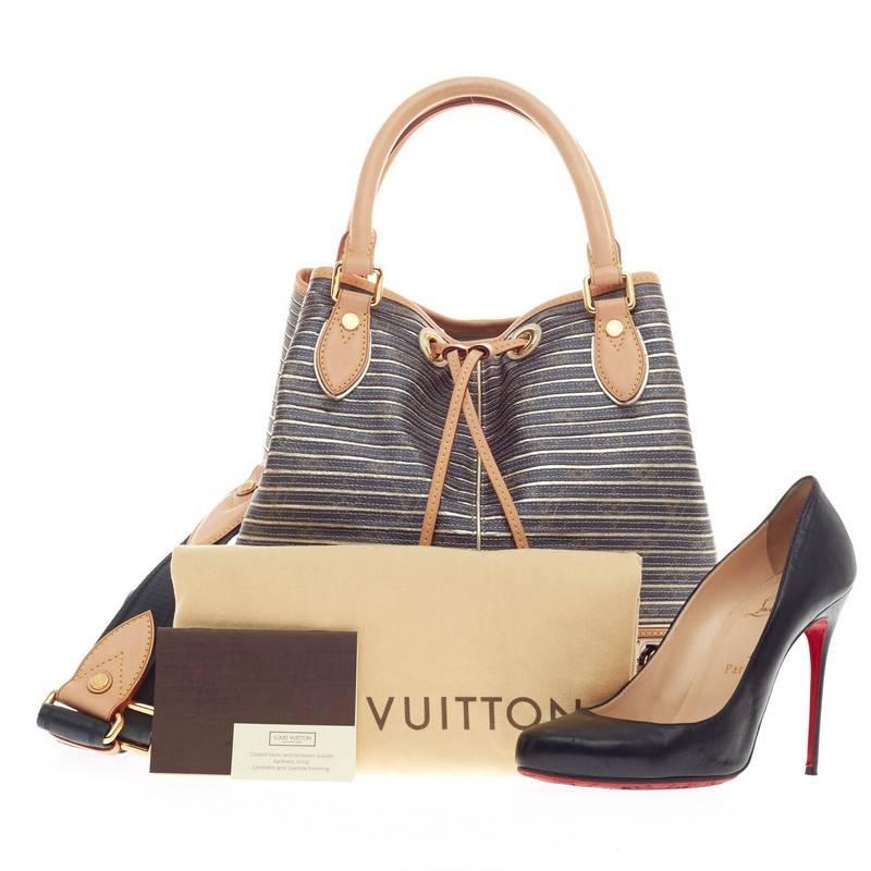 This authentic Louis Vuitton Neo Shoulder Bag Limited Edition Monogram Eden from Spring/Summer 2010 in monogram canvas and metallic argent gold stripes is definitely a collectors item. The Eden line revisits LV’s classic pieces with a modern