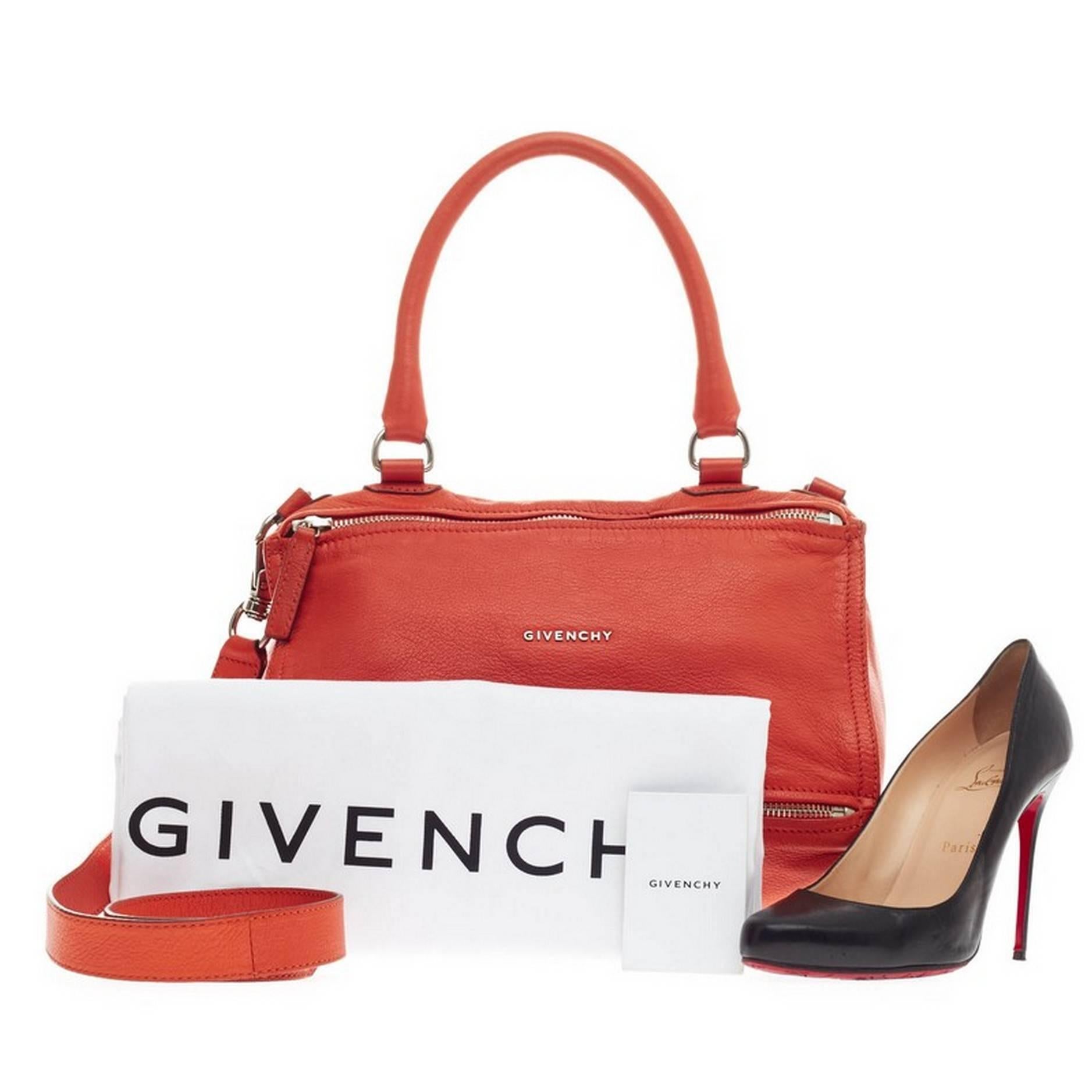 This authentic Givenchy Pandora Bag Leather Medium is the perfect companion for any on-the-go fashionista. Crafted in orange grainy leather, this edgy and cult-favorite satchel features a pandora box-inspired silhouette, a singular top handle, an