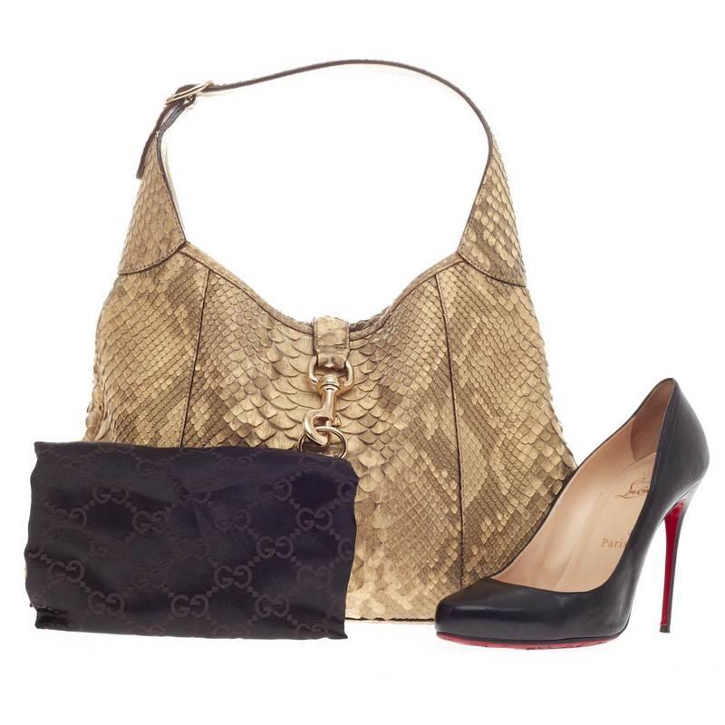 This authentic Gucci Jackie O Python Medium is a must-have luxurious everyday hobo fit for the modern woman. Constructed from dusty yellow genuine python skin with tan undertones, this iconic bag features an adjustable shoulder strap, lobster hook