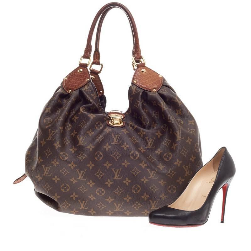 This authentic Louis Vuitton XL Hobo Monogram Canvas and Alligator is a rare, collector's piece with only a handful made. Constructed in beautiful monogram canvas with tan alligator trims, this luxurious, feminine-style hobo features an  engraved