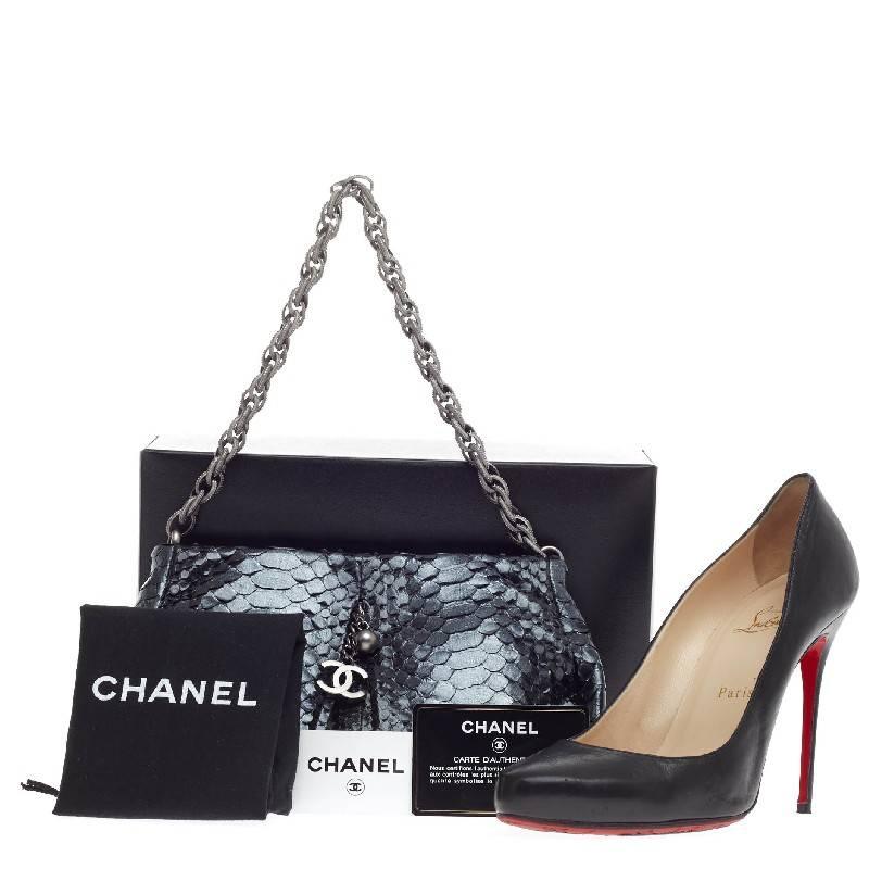 This authentic Chanel Chain Strap Pochette Mini is elegant and eye-catching for special occasions and night outs. Constructed in lustrous metallic deep blue with gray undertones, this pleated clutch features a matte silver bijoux chain strap, front
