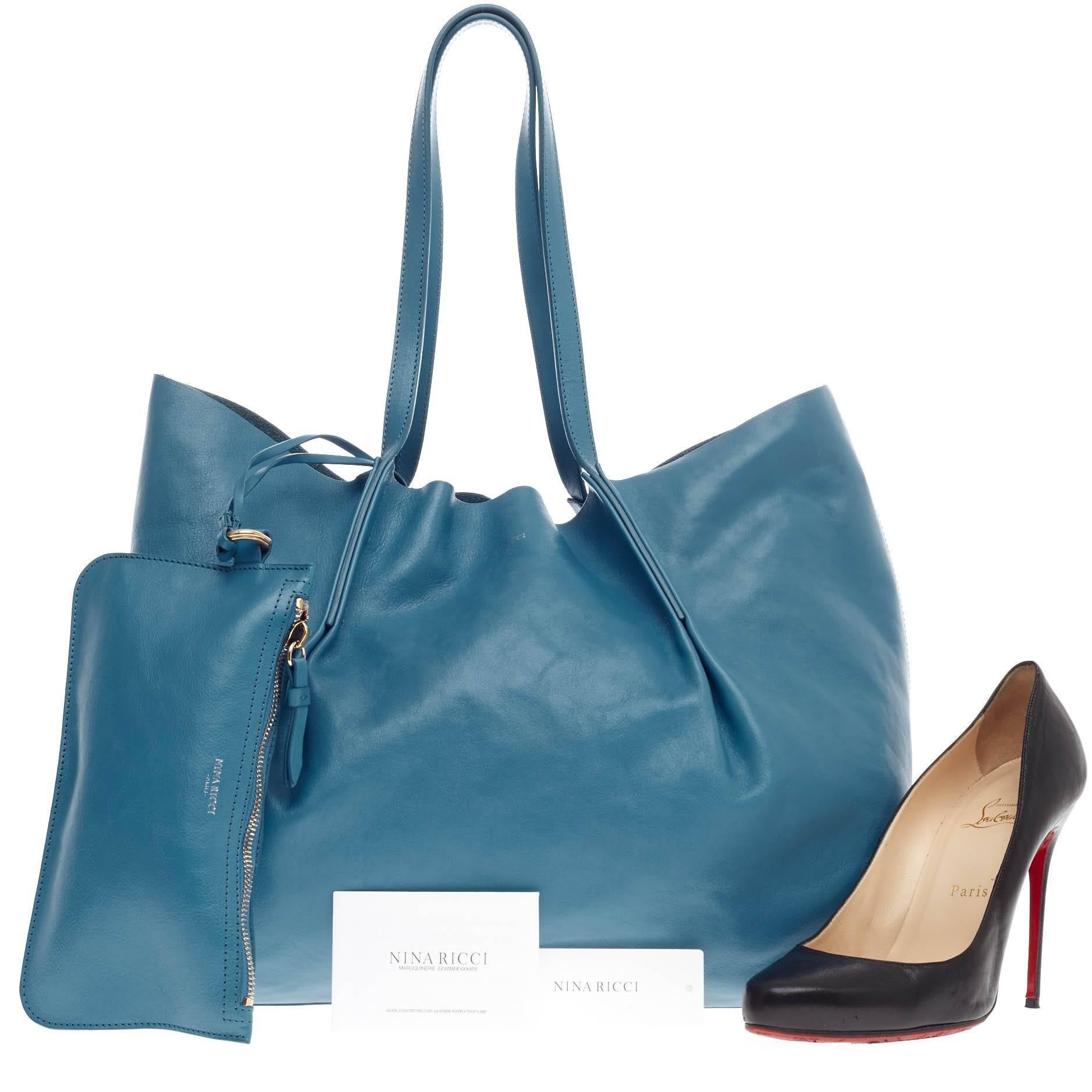 This authentic Nina Ricci Ondine Tote Leather is an easy-to-go shopper tote made for everyday excursions. Crafted in soft aqua marine leather, this lightweight tote features dual-top slim handles, top stitched cinched pleating, and gold stamped Nina