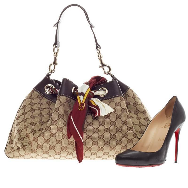 This authentic Gucci Positano Shoulder Bag GG Canvas Medium balances a casual style with a chic twist. Constructed in Gucci's brown monogram canvas, this elegant shoulder bag features brown leather trims, single looped shoulder strap, stand-out