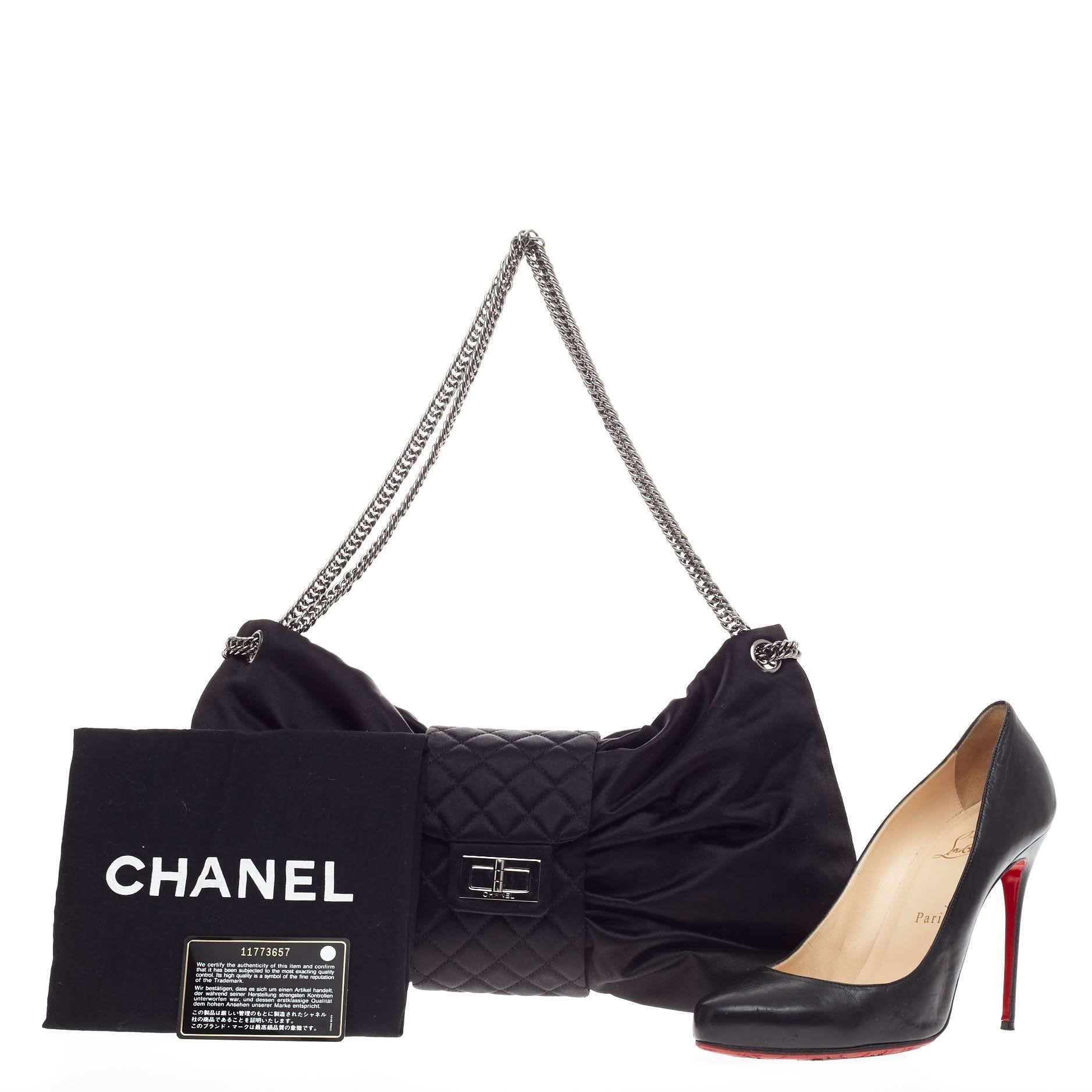 This authentic Chanel Bow Bag Satin Large presented in the brand's Spring/Summer 2008 Collection is  stylish and luxurious in design perfect for day to evening look. Crafted in soft black satin, this unique bow bag features Chanel's signature