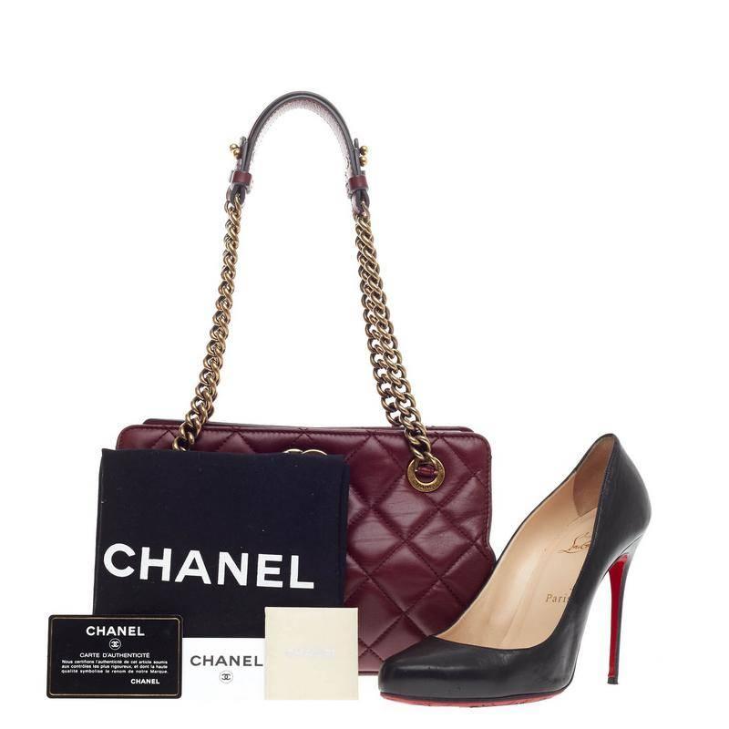 This authentic Chanel CC Crown Tote Quilted Leather Small presented from the brand's 2013 Cruise Collection mixes chic style with vintage-inspired detailing. Crafted in dark maroon quilted lambskin, this chic tote features aged brass chain hardware
