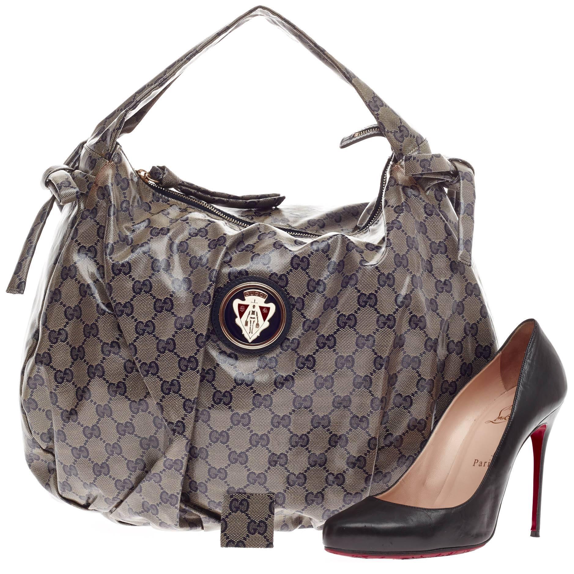 This authentic Gucci Hysteria Hobo GG Coated Canvas is a fall must-have. Crafted in blue and gray GG monogram coated canvas, this luxurious yet feminine hobo features a single loop handle, pleated silhouette, side bow detailing, brass Gucci emblem