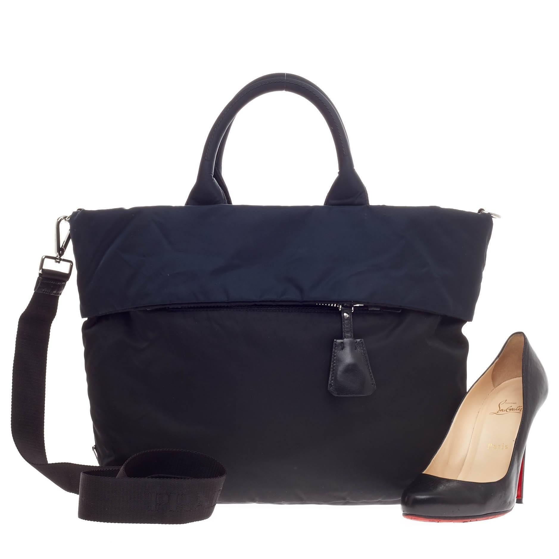 This authentic Prada Double Tote Tessuto is ideal for the on-the-go care free individual. Crafted from navy and black tessuto, this reversible, functional tote features dual-rolled handles, detachable strap, front zip pocket and silver-tone hardware