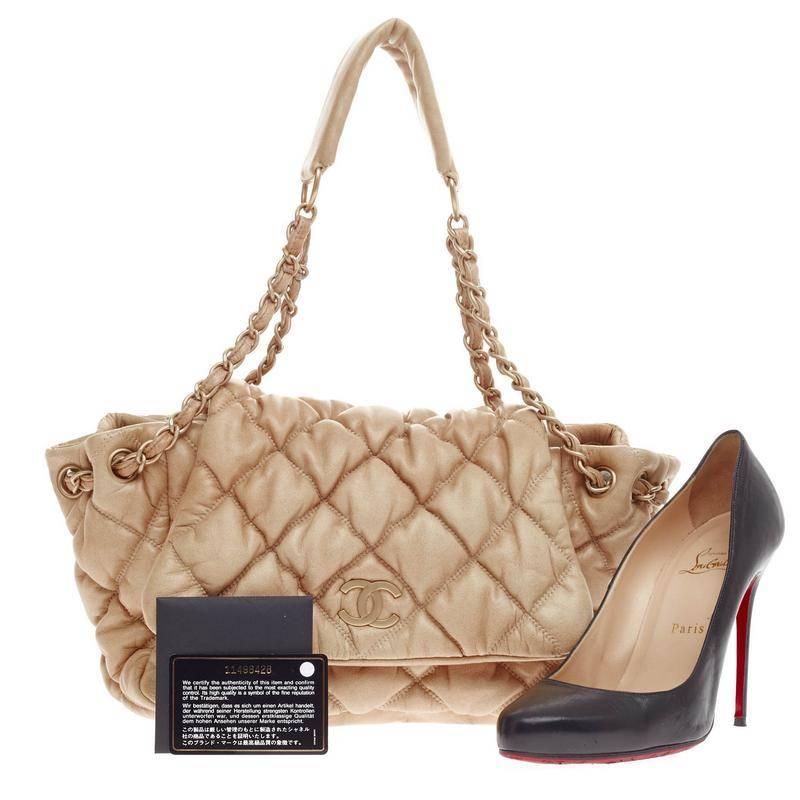 This authentic Chanel Bubble Quilt Flap Accordion Flap Lambskin is sure to compliment just about every casual outfit. Crafted in beige bubble quilted leather, this soft, puffy flap bag features woven-in leather chain strap threaded through eyelets