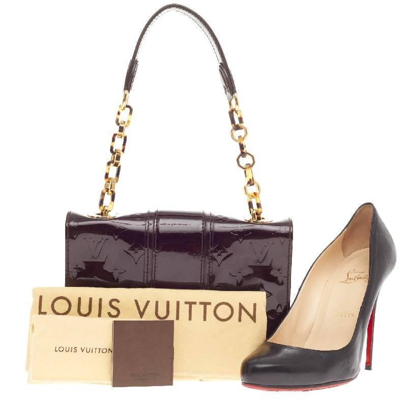 This authentic Louis Vuitton Vermont Avenue Monogram Vernis is ideal for on-the-go women. Crafted in amarante monogram vernis leather, this day-to-evening chain bag features an oversized gold-chain link strap with tortoise resin accents, frontal