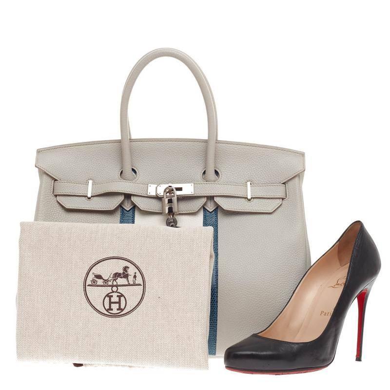 This authentic Hermes Club Birkin Etain, Graphite Clemence and Gris Fonce Lizard 35 showcases subtle elegance with a playful twist. Finely crafted in luxurious gris perle with white clemence leather paneling, this one-of-a-kind piece features a