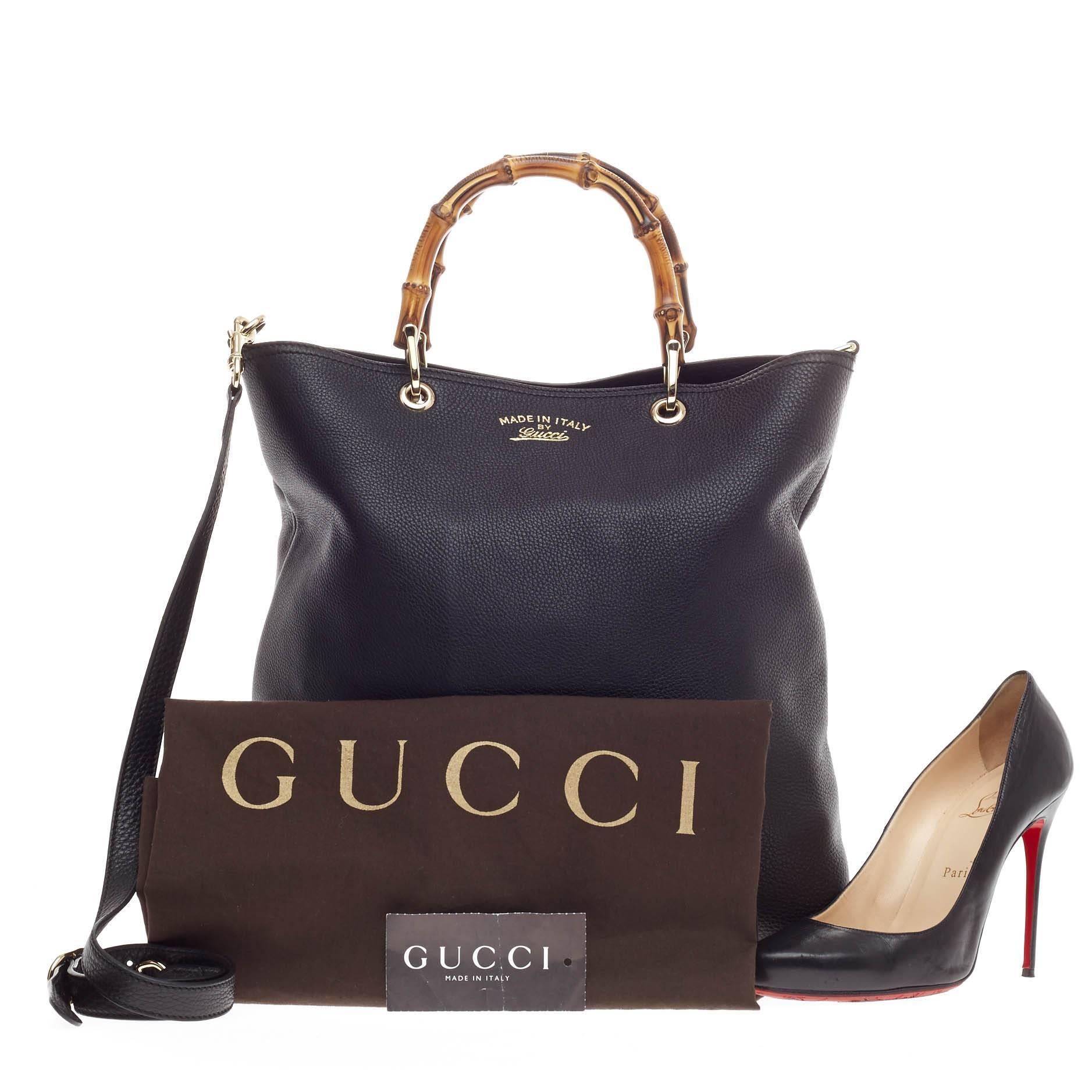 This authentic Gucci Bamboo Shopper Tote Leather Tall is a classic must-have. Crafted in classic black grainy leather, this vertical tote features Gucci's signature sturdy bamboo handles, stamped logo at the front and faded gold-tone hardware