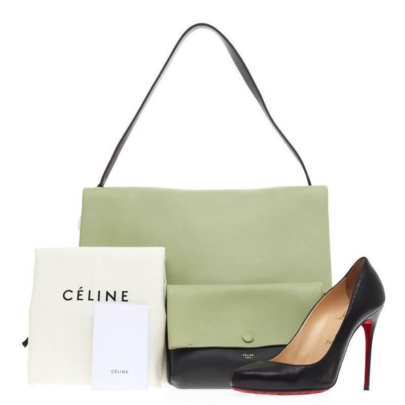 This authentic Celine All Soft Tote Leather designed in mint green and dark gray calfskin leather with beige suede underneath its flap. It displays a neutral and understated look perfect for the modern woman. This no-fuss tote features a single