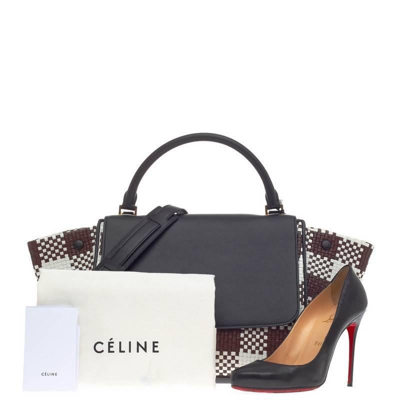 This authentic Celine Trapeze Woven Leather Medium is a modern classic, showcasing an eye-catching motif perfect for casual wear. Designed in brown and white checkered woven leather, this minimalist tote features a black leather frontal flap with