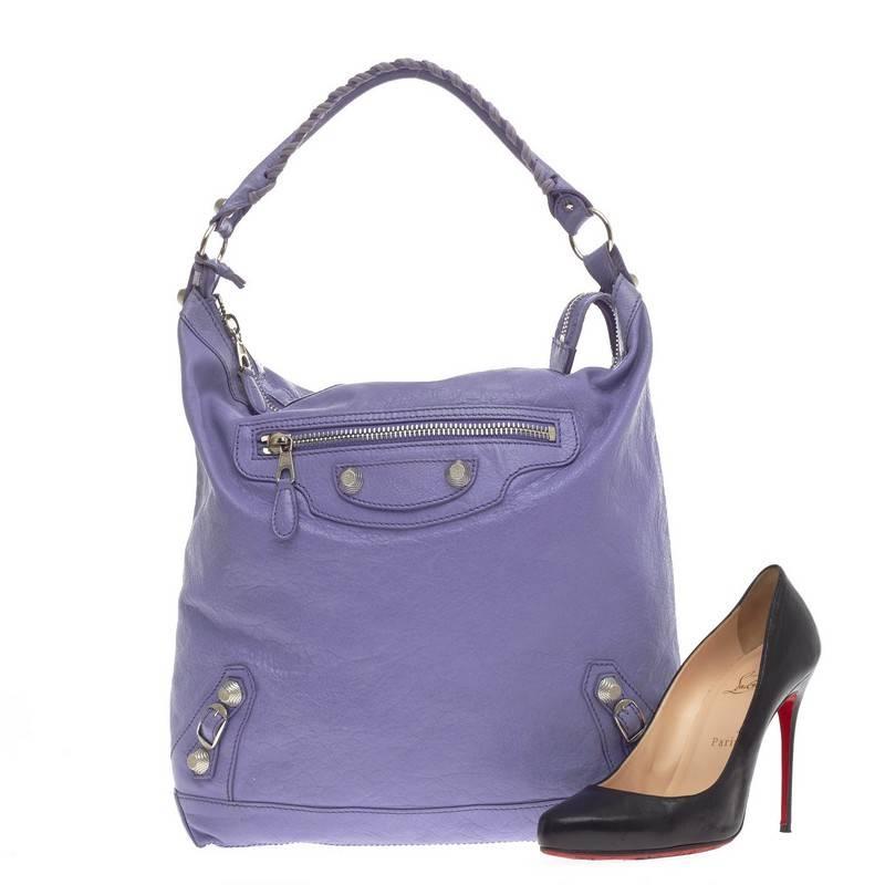 This authentic Balenciaga Day Hobo Giant Studs Leather in beautiful lavender distressed leather is a go-to essential that fits everyday items. This spacious hobo is accented with an intertwined braided leather top handle, front exterior zip