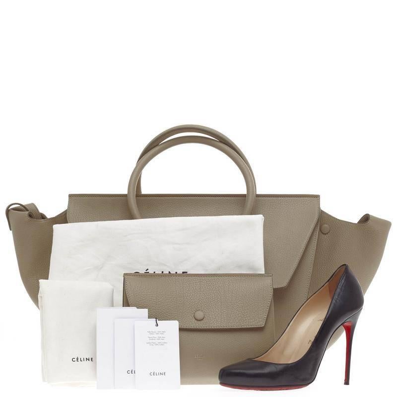 This authentic Celine Tie Knot Tote Grainy Leather Small is an absolute must-have for serious fashionistas. Crafted from taupe beige grainy calfskin leather, this boxy, chic tote features dual-rolled leather handles with signature knot accents,