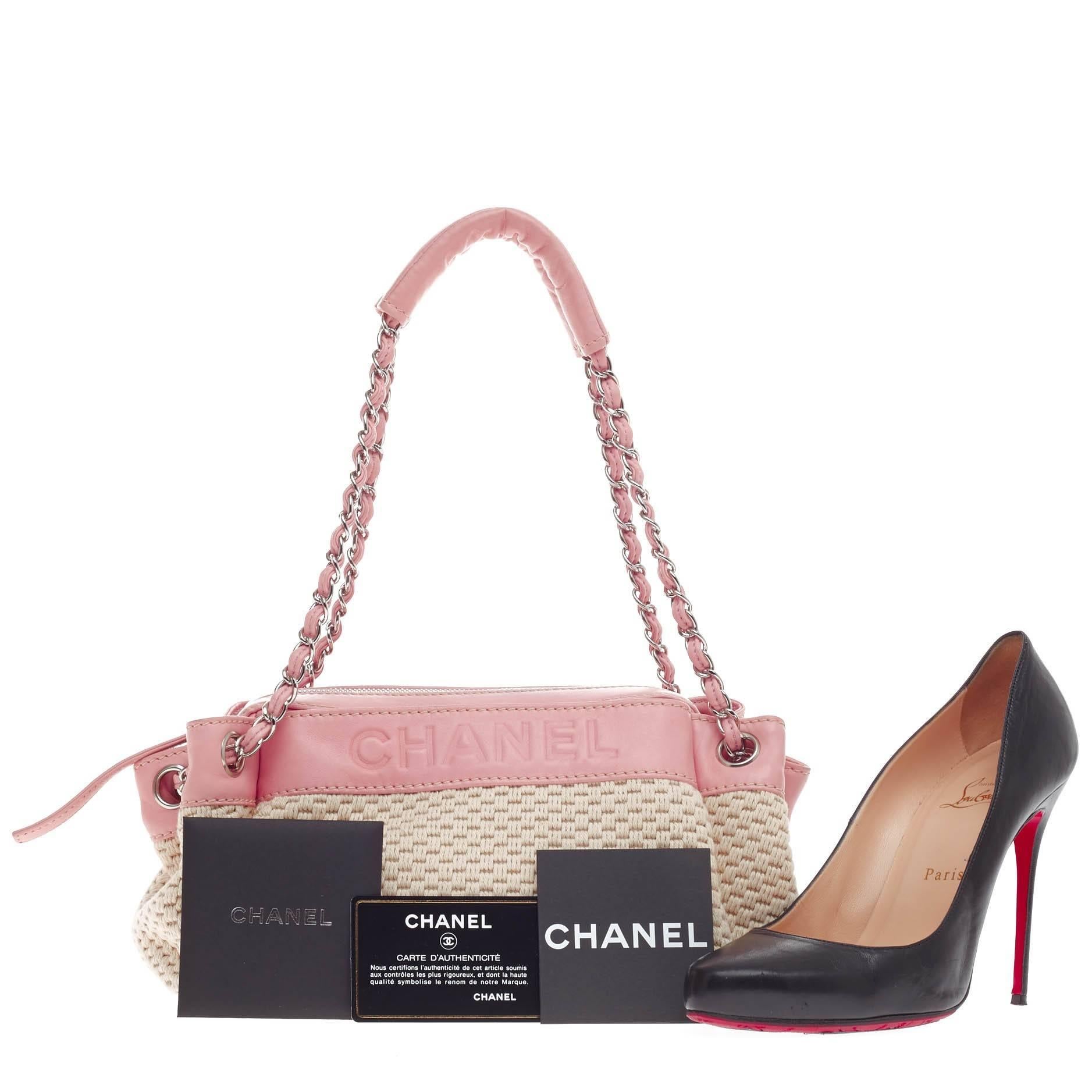 This authentic Chanel LAX Accordion Camera Bag Leather and Woven Fabric Small is ideal for summer escapades. Crafted in beige woven fabric with pink leather trims, this feminine and lightweight camera bag features woven-in leather chain straps that