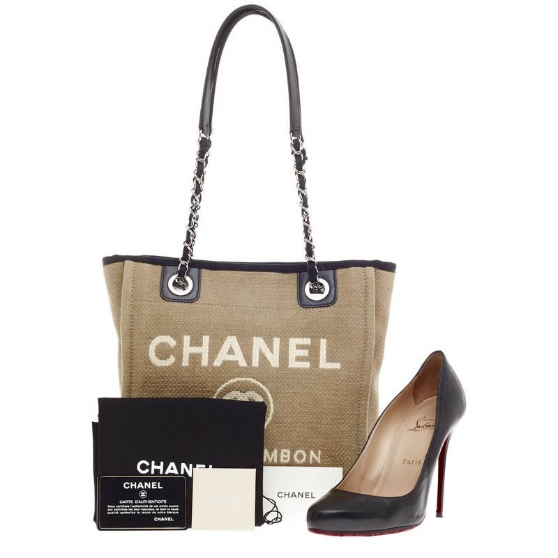 This authentic Chanel Deauville Chain Tote Canvas Small first seen during the brand's Spring/Summer 2012 Collection embodies a casual-chic style made for any fashionista. Crafted in lightweight sandy canvas with contrast black trimmings, this