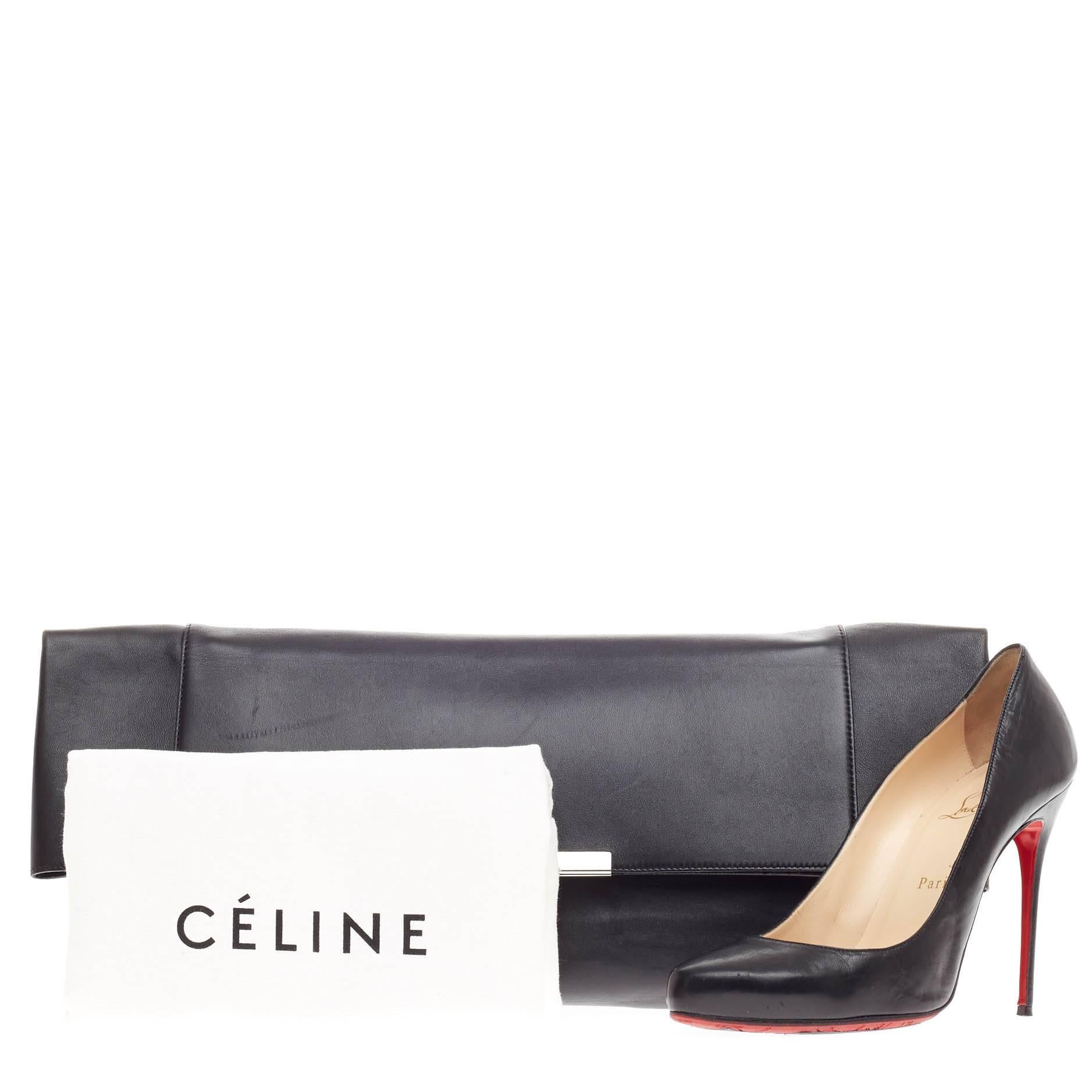 This authentic Celine Folded Clutch Leather Large presented in the brand's Fall/Winter 2012 Collection is perfect for day to night outs. Crafted in smooth black calfskin leather, this oversized, tailored folded clutch features a Celine stamped logo