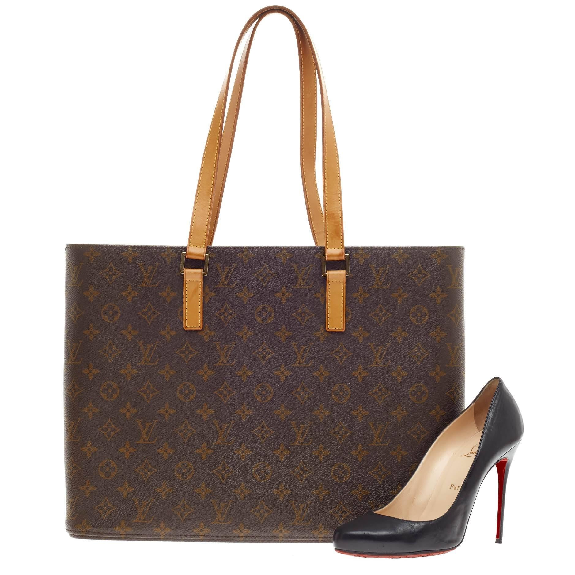 This authentic Louis Vuitton Luco Tote Monogram Canvas is a classic tote design crafted with the brand's iconic LV monogram leather print. The sturdy base allows the bag to stand freely and the multiple interior pockets is designed for easy
