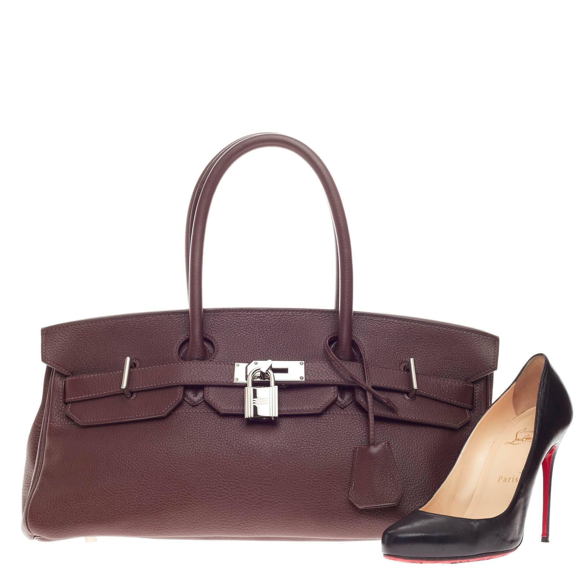 This authentic Hermes Birkin JPG Chocolate Clemence with Palladium Hardware 42 aptly named from its designer Jean Paul Gaultier is an elongated reinterpretation of the Hermes' classic Birkin design. Crafted in brown clemence leather, this shoulder