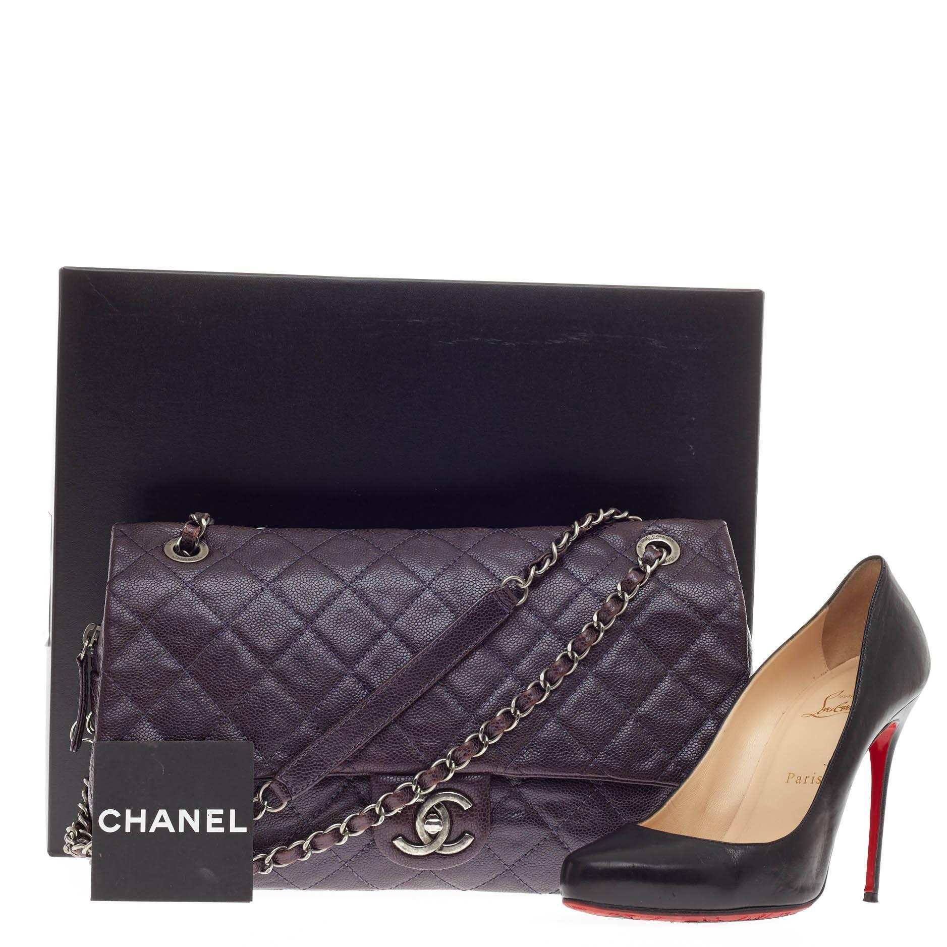 This authentic Chanel Easy Flap Bag Caviar Jumbo released in the brand's 2012 Collection exudes a classic yet easy style made for the modern woman. Crafted in deep plum caviar with brown undertones, this elegant flap features Chanel's signature
