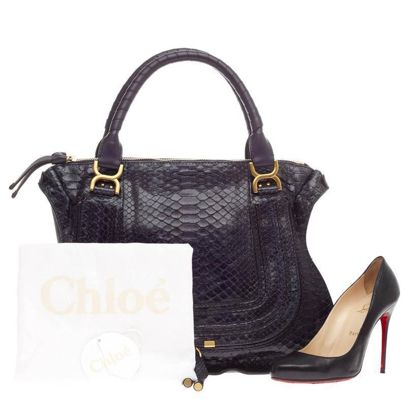 This authentic Chloe Marcie Satchel Python Large is perfect for an on-the-go fashionista. Constructed from genuine dark navy python skin, this ultra-chic, oversized satchel features wrapped leather handles, horseshoe stitched front flap, pebbled