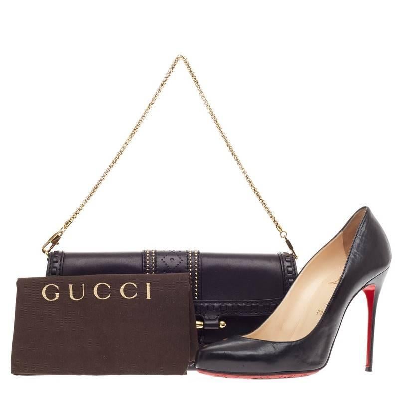 This authentic Gucci Snaffle Bit Convertible Clutch Leather presented in the brand's Spring/Summer 2011 Collection is perfect for day to night outfits. Crafted in classic black leather, this edgy, romantic chain clutch features perforated detailing,
