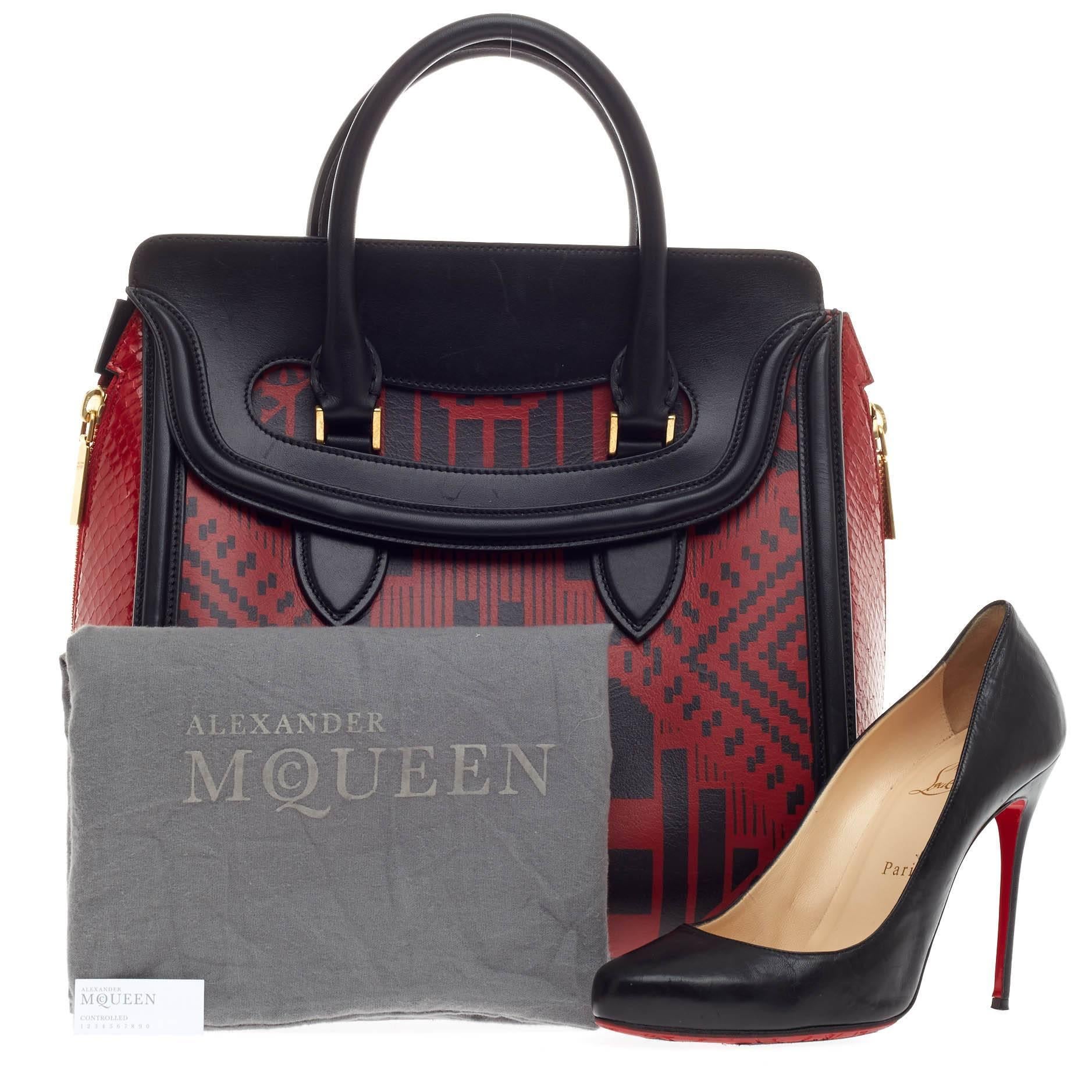 This authentic Alexander McQueen Heroine Tote Leather and Python combines edgy style with luxurious design. Crafted in red and black leather with an abstract patchwork design, this structured bag features red genuine glazed python skin side