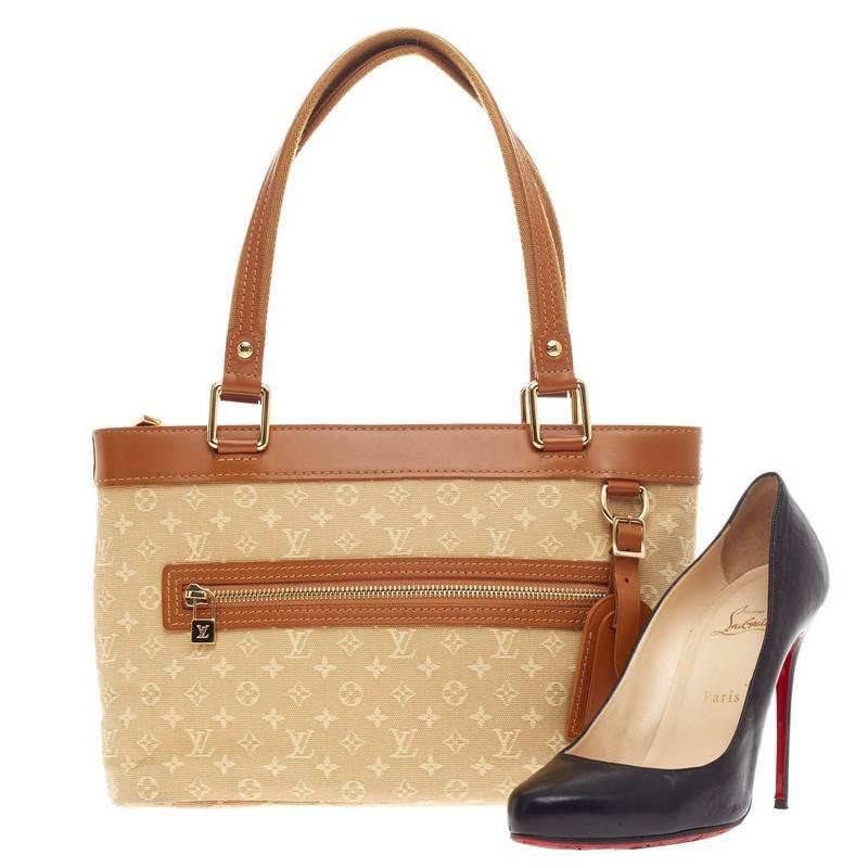 This authentic Louis Vuitton Lucille Mini Lin PM is simple and classic ideal for your everyday casual look. Crafted in signature beige monogram mini lin canvas, this simple tote features camel leather trims and handles, front zip pocket, leather tag