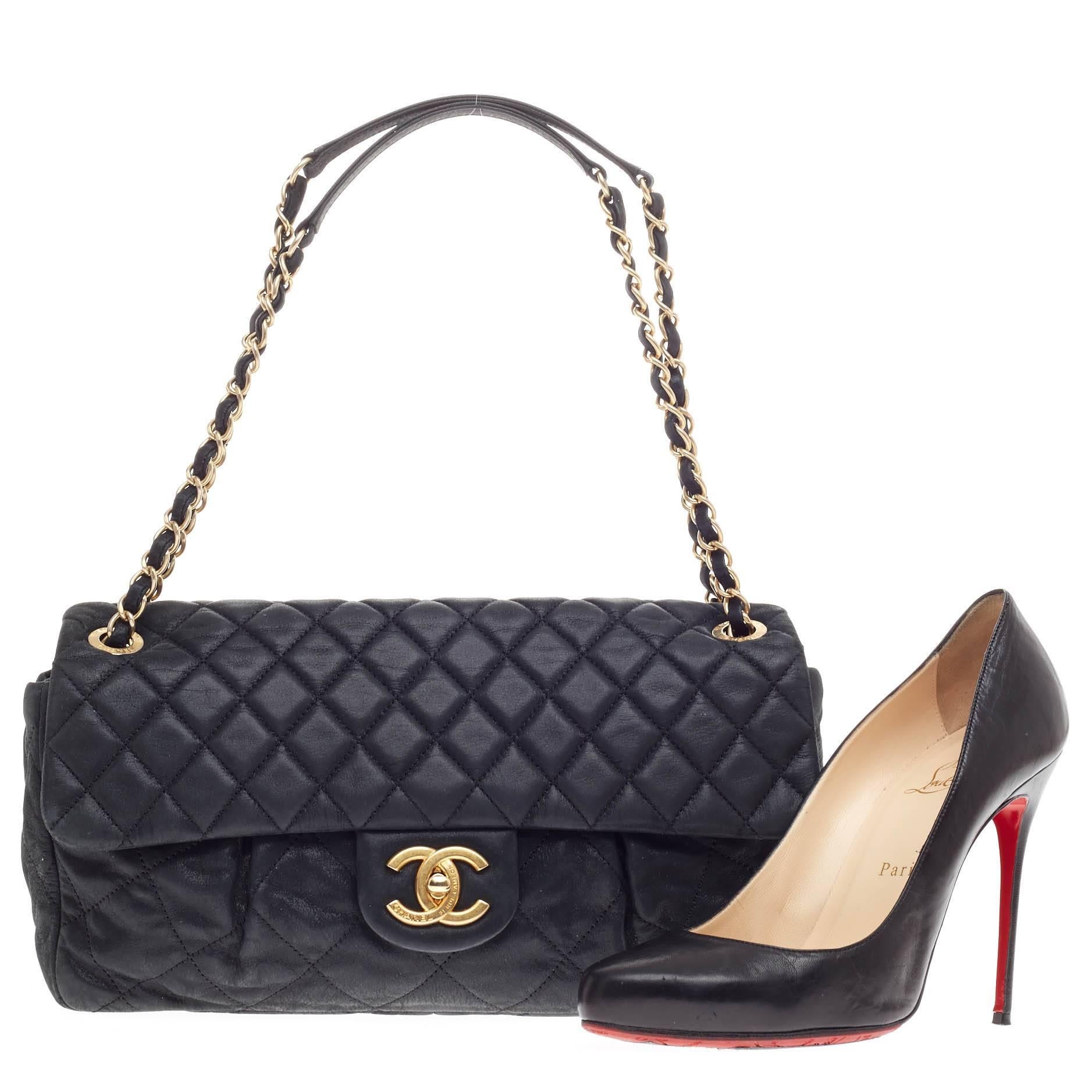 This authentic Chanel Chic Quilt Flap Bag Quilted Iridescent Leather Large presented in the brand's 2011-2012 Collection in luxurious navy iridescent calfskin is a sumptuous accessory that adds a touch of glamour to any look. Designed in Chanel's
